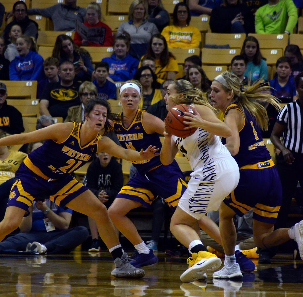 Jordan Chavis protects the ball while from Western Illinois' Grace Gilmor, Annabel Graettinger, and Danni Nichols